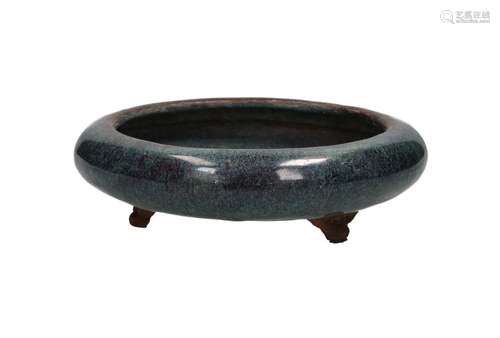 A blue glazed Yixing tripod bowl with speckles, on a carved ...