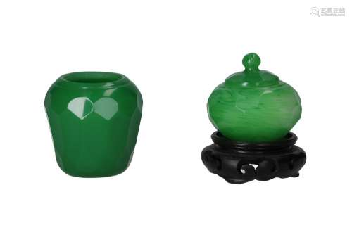 Two cut jade green glass jars, a lidded jar on a wooden base...