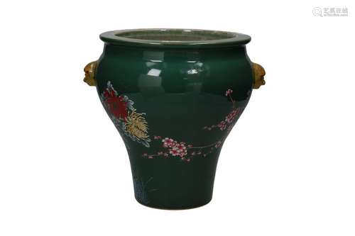 A green glazed porcelain vase with a polychrome decoration o...