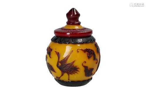 A Peking glass jar with a carved decoration of animals. Chin...