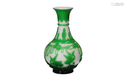 A green on white glass pipe bottle vase, decorated with alsu...