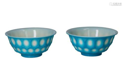 A pair of blue on white glass bowls with a hexagonal carved ...