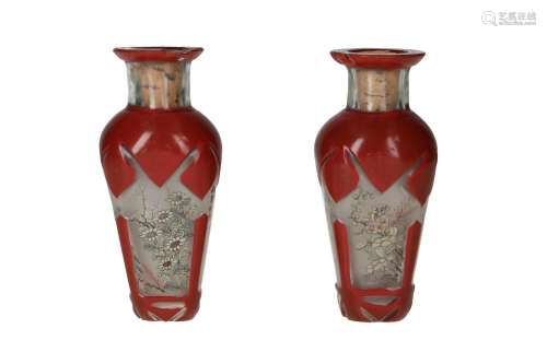 A pair of glass vases, with brown glass details, and a decor...