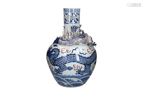 A blue and underglazed red porcelain vase with a carved drag...