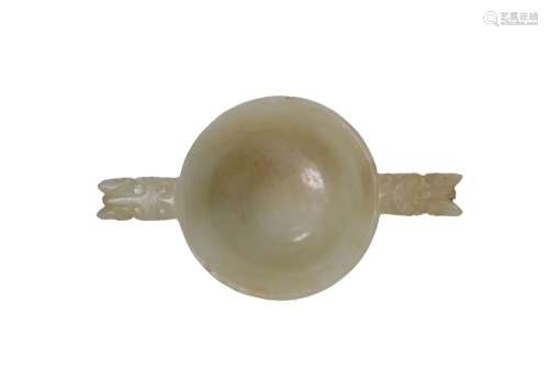 A cup carved from jade with a floral relief and two handles ...