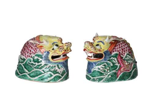 A pair of polychrome porcelain sculptures depicting dragon h...
