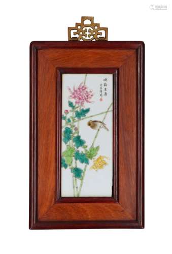 A set of three polychrome porcelain plaques in frame, depict...