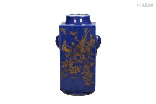 A blue glazed porcelain cong vase with two handles in the sh...