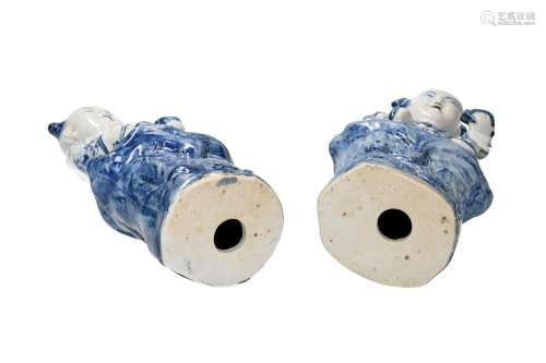 Three blue and white porcelain lucky figurines sitting on a ...