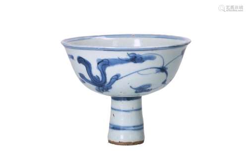 A blue and white porcelain wine cup, decorated with flowers....