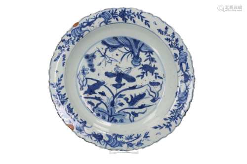 A blue and white porcelain deep charger with a scalloped rim...
