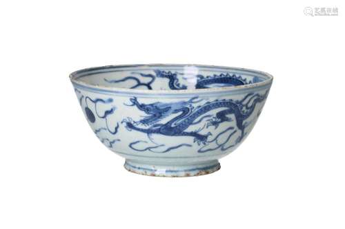 A blue and white porcelain bowl, decorated with dragons chas...