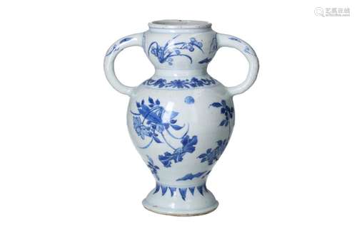 A blue and white porcelain vase with two handles in the shap...