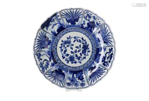 A blue and white Arita porcelain deep charger with scalloped...