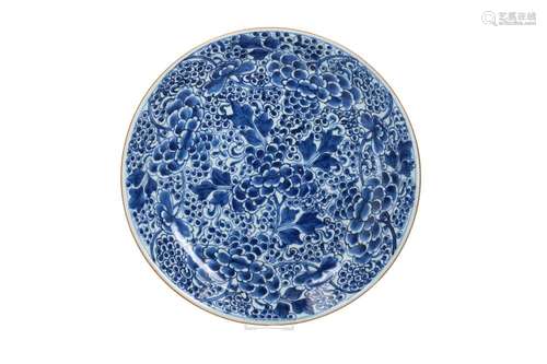 A blue and white porcelain charger with a floral decoration....