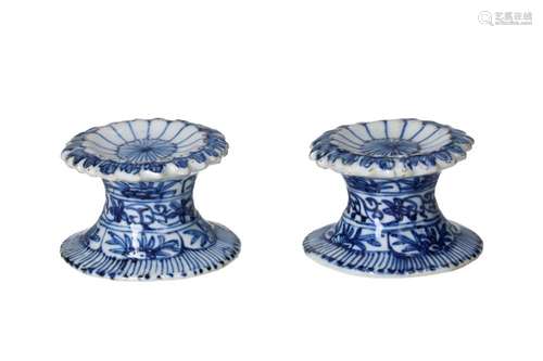 A pair of blue and white porcelain salt cellars, decorated w...