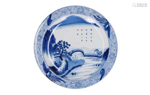 A blue and white porcelain dish decorated with a landscape b...