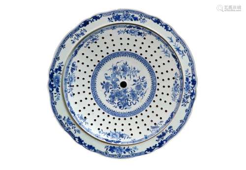 A blue and white porcelain perforated dish on a saucer decor...