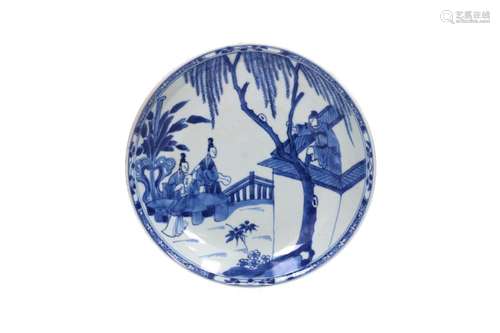 A blue and white porcelain plate decorated with a scene of t...