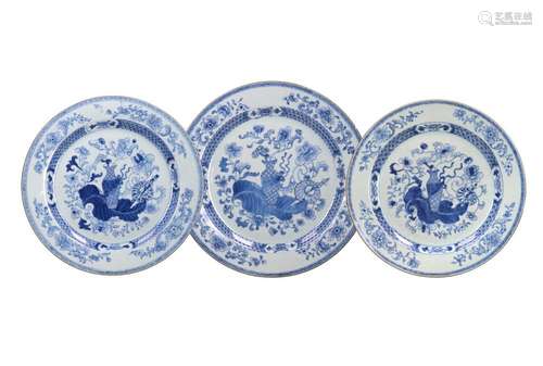 A set of three blue and white porcelain chargers, decorated ...