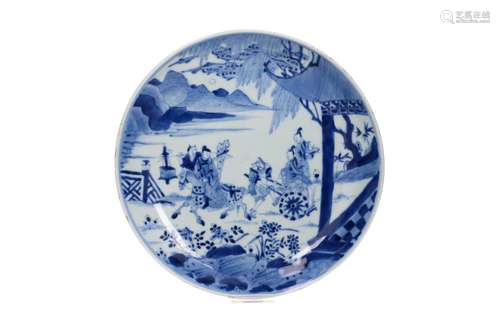 A blue and white porcelain plate decorated with a scene of t...