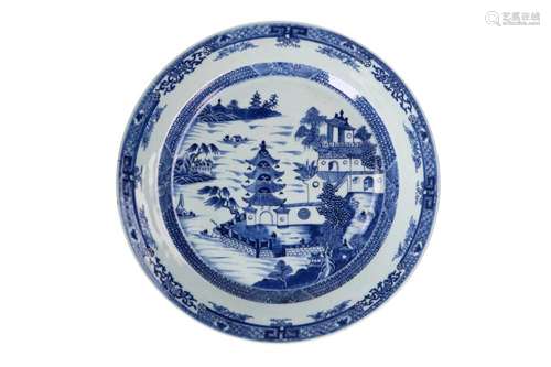 A blue and white porcelain charger, decorated with pagodas i...