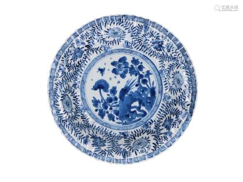 A blue and white porcelain deep dish with scalloped rim, dec...