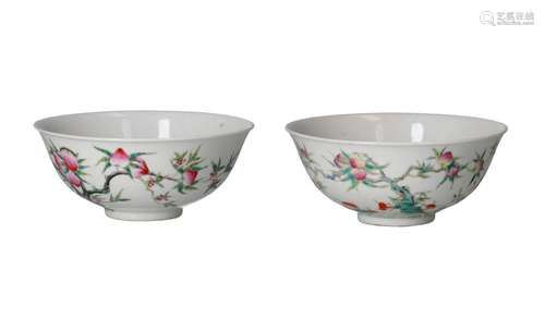 A near pair famille rose porcelain bowls with a decor of pea...