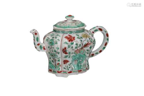 A famille verte porcelain teapot outlined in relief on three...