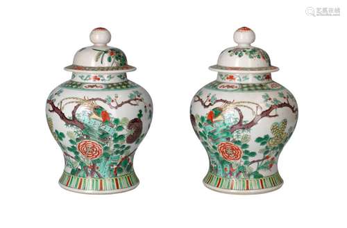 A pair of famille verte porcelain lidded baluster vases, dec...