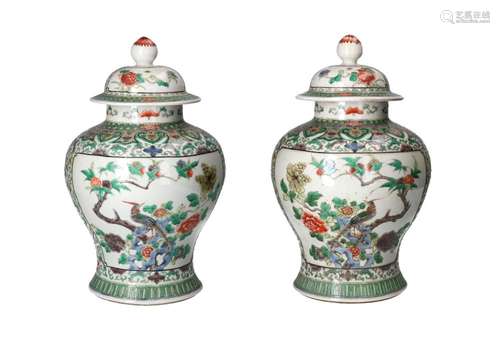 A pair of famille verte porcelain lidded vases, decorated wi...