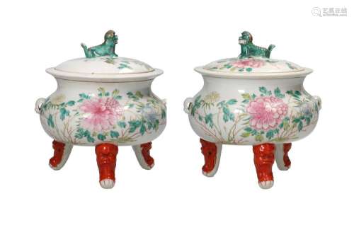 A pair of polychrome porcelain tripod lidded jars with two h...