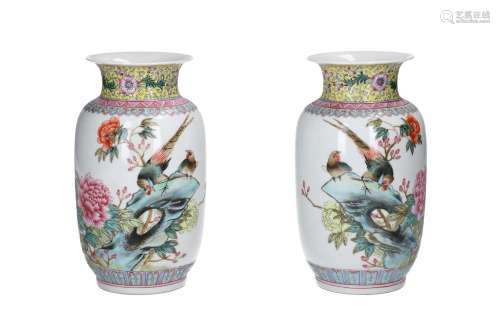 A pair of polychrome porcelain vases, decorated with birds a...