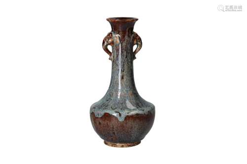 A flambé glazed stoneware vase with two grips in the shape o...