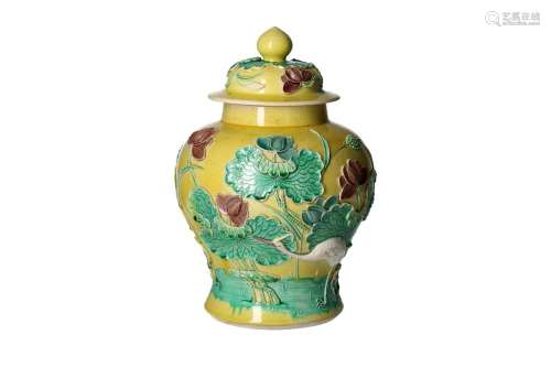 A polychrome porcelain vase with carved decoration depicting...