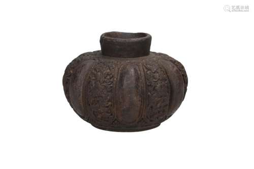 A black-brown faience earthenware jar in the shape of a pump...