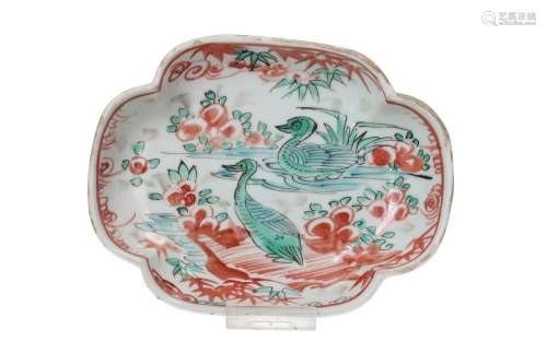 A polychrome porcelain dish with scalloped rim, decorated wi...