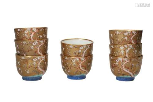 A set of eight polychome porcelain cups, decorated with cher...