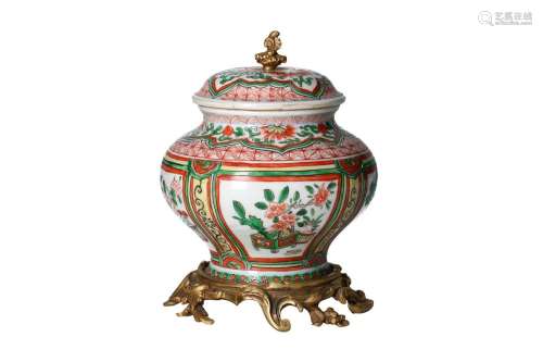 A famille verte porcelain lidded jar on a gilt bronze base, ...