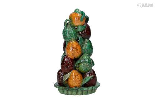 A stack of green, yellow and aubergine glazed earthenware po...