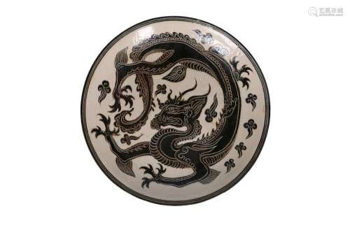 A Cizhou ware charger, decorated with a three-toed dragon. C...