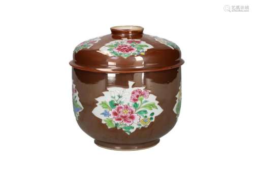 A capucine porcelain lidded jar with famille rose decor in t...