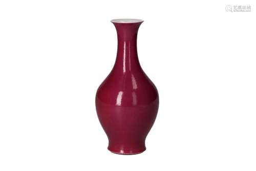 A sang de boeuf glazed porcelain baluster vase. Marked with ...