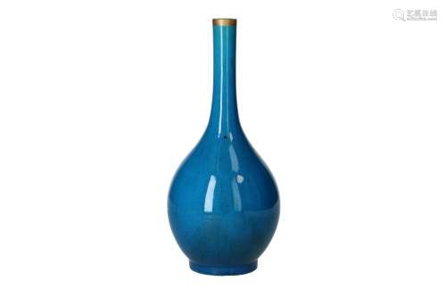 A monochrome blue porcelain bottle vase with gold coloured r...