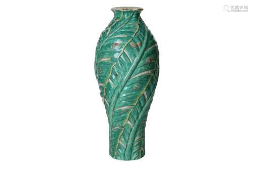 A green glazed porcelain vase with relief decor of banana le...
