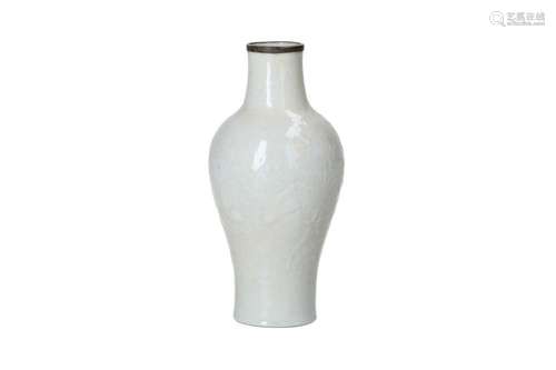 A white glazed eggshell porcelain vase with relief decor of ...