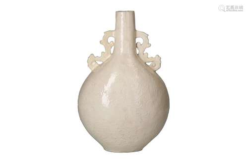 A white glazed porcelain moonflask with two handles and reli...