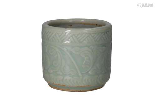 A celadon glazed porcelain brush pot with a floral relief de...