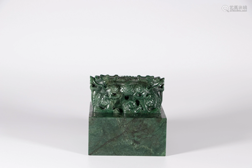 A Chinese spinach green-jade seal, carved with dragons