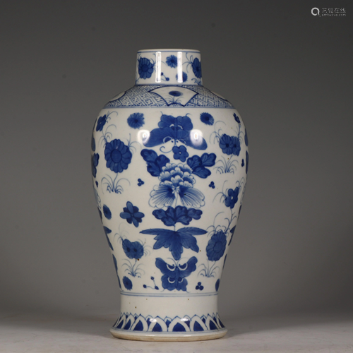 A blue and white vase, decorated with butterflies